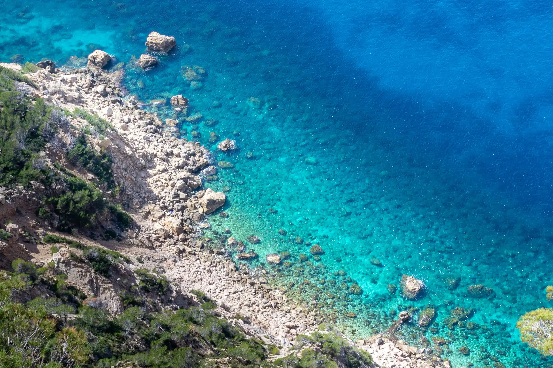 Aerial view of the rocky Serra de Tramuntana coastline with turquoise sea, Mallorca